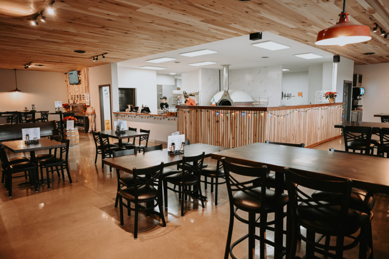 Restaurant space at the newly renovated and modern commercial space, The Railyard, in Garrett, Indiana, with natural elements and industrial lighting fixtures.