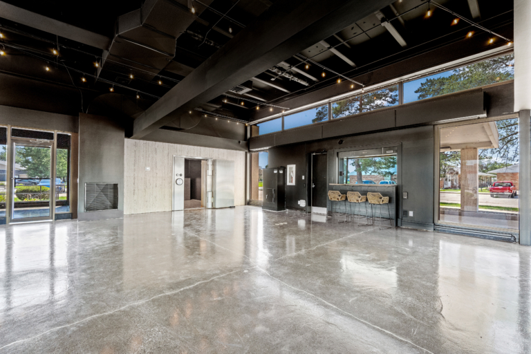 Open event space with natural light and sealed concrete floors of The Vault event center in Garrett, Indiana.